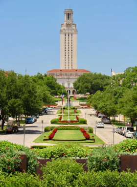  A striking view of the University of Texas Tower, an iconic landmark on campus. The tower stands tall against a clear blue sky, symbolizing education and history in Austin.

