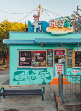  A view of the South Congress (SoCo) shopping district, featuring a variety of unique and eclectic shops. The street is lined with colorful storefronts and vibrant displays, attracting both locals and tourists.

