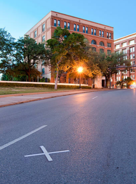  "Historic Dealey Plaza in Dallas, Texas, featuring the Texas School Book Depository building, a site known for its significance in American history and popular with tourists."
