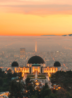 “Griffith Observatory overlooking the night skyline of Los Angeles, with stars visible in the clear sky above the city.”

