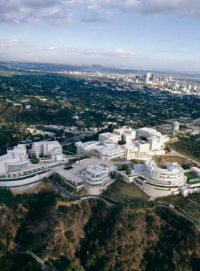 “Aerial view of Los Angeles cityscape with mountains in the background, highlighting the vast urban sprawl and natural surroundings.”