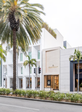 “Exterior of a Chanel boutique with elegant window displays, showcasing luxury fashion in a modern retail space.”