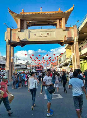 : A vibrant scene from the Chinese Food and Cultural Festival in Port Louis, featuring traditional decorations and visitors enjoying the festivities.