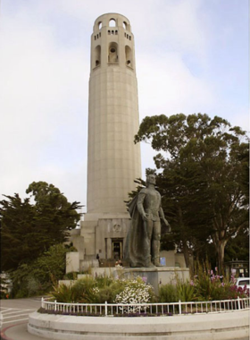 Coit Tower standing proudly atop Telegraph Hill, surrounded by vibrant gardens and the city of San Francisco in the background. The white structure is a prominent landmark against the blue sky, symbolizing the city’s rich history.