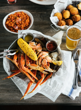 A deliciously arranged seafood platter featuring steamed crabs, accompanied by corn on the cob and potatoes. The vibrant colors of the crab shells contrast with the earthy tones of the vegetables, showcasing the rich culinary tradition of Charleston’s seafood cuisine.