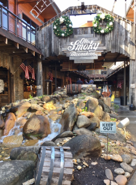 The charming entrance of Ole Smoky Distillery, inviting visitors to explore the world of moonshine. The rustic design and festive decorations reflect the lively spirit of this popular attraction in Gatlinburg.