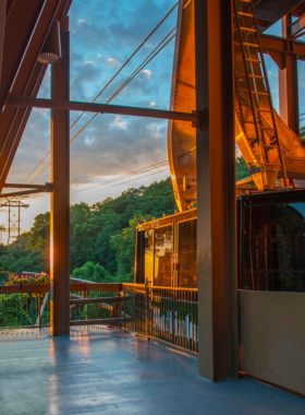 A stunning sunrise over Ober Mountain, illuminating the sky with warm hues of orange and yellow. The scene showcases the tranquil beauty of the mountain landscape, inviting visitors to enjoy a day of outdoor adventure.