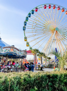 Visitors enjoying thrilling rides and interactive exhibits at WonderWorks in Myrtle Beach. The building's upside-down design adds to the excitement of this educational and fun destination.