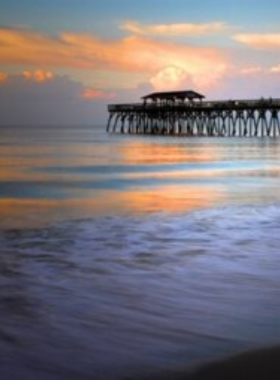  A scenic shot of the beautiful coastline along Myrtle Beach, with clear skies and rolling waves. The beach offers a relaxing atmosphere, perfect for swimming, sunbathing, and enjoying the ocean breeze.