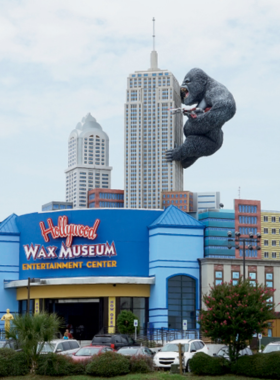 A wide shot of the Myrtle Beach Wax Museum, showcasing lifelike wax figures of famous personalities. The museum’s exterior features a distinctive architectural design with a large entryway, drawing visitors eager to explore exhibits.