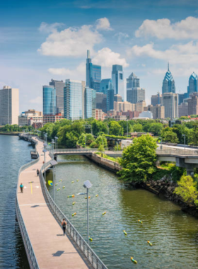 A panoramic view of downtown Philadelphia, with skyscrapers towering over the city. The iconic skyline includes historic and modern buildings, showcasing the city’s blend of tradition and progress.