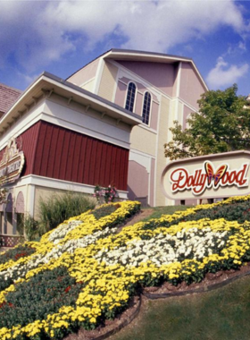 The entrance to Dollywood in Pigeon Forge, with signage and flower arrangements welcoming visitors to this popular theme park. The park is a top attraction in the Smoky Mountains.