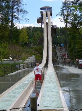 A thrilling tall water slide at Splash Country water park in Pigeon Forge. The slide twists and turns, providing a refreshing and exciting experience for park visitors.