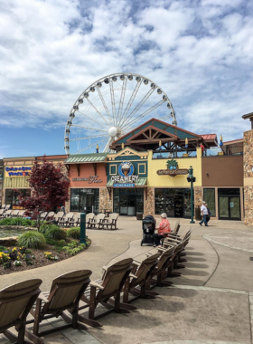 The Island at Pigeon Forge, featuring a beautiful outdoor fountain and shopping area. The location is a popular entertainment and shopping destination, bustling with activity and visitors.