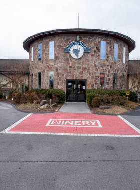  Mountain Valley Winery in Sevierville, showcasing a charming vineyard and tasting room. The winery is nestled against scenic mountain landscapes, offering a relaxing atmosphere for wine lovers.