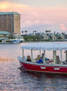 A peaceful scene of an electric boat cruising along the Hillsborough River at eBoats Tampa, with visitors enjoying the relaxing experience while taking in the beautiful waterfront views.