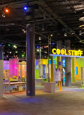 This image shows that children and families are actively engaging with interactive science exhibits at Discovery Place Science, where visitors can learn through hands-on activities and displays.