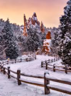 This image shows the breathtaking red rock formations at Garden of the Gods, with towering sandstone rocks set against a bright blue sky and the distant mountains.