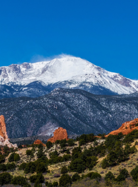 This image shows visitors enjoying outdoor adventure activities in Colorado Springs, such as hiking, biking, and exploring the stunning natural landscapes.