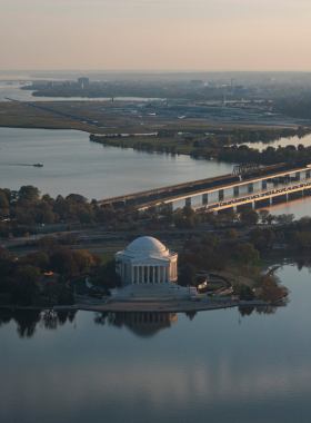 This image shows a scenic view from a Potomac River cruise, highlighting famous D.C. landmarks along the waterfront.