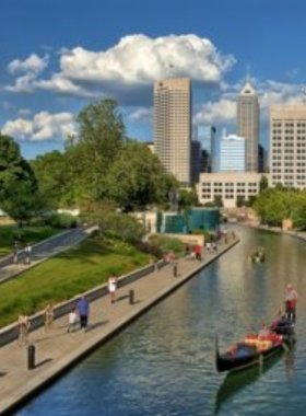 "This image shows people enjoying a serene stroll and pedal boating along the Central Canal in downtown Indianapolis."