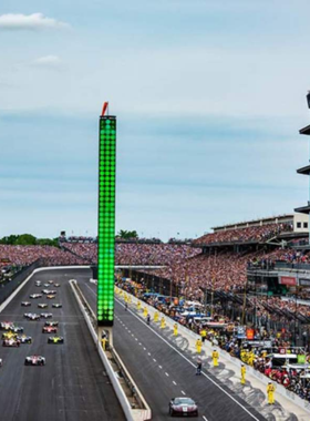 This image shows the iconic Indianapolis Motor Speedway track, including the Hall of Fame Museum with vintage race cars on display."