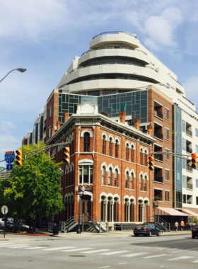 This image shows a vibrant street on Massachusetts Avenue, with art galleries, shops, and cafes filled with visitors."