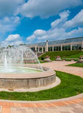 "This image shows the Garfield Park Conservatory’s Sunken Gardens, with beautifully arranged flower beds and a peaceful walking path."