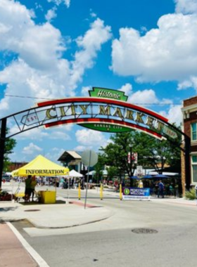  "This image shows vendors selling fresh vegetables at the City Market in Kansas City, a popular spot for buying local produce and enjoying the vibrant atmosphere."