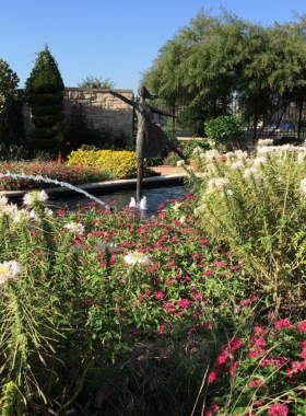 "This image shows the serene Ewing and Muriel Kauffman Memorial Garden in Kansas City, with lush greenery, flowers, and a peaceful atmosphere perfect for relaxation."