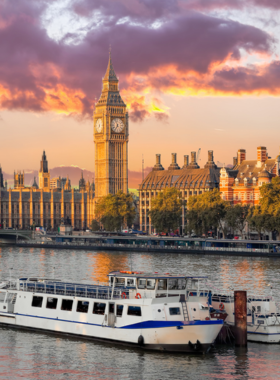 This image shows a scenic Thames River cruise boat with views of iconic London landmarks in the background.