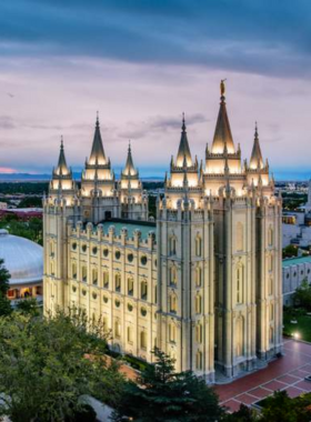 This image shows that the Salt Lake Temple stands tall with its impressive architecture and high spires against a bright sky."