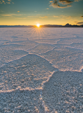 "This image shows that the Bonneville Salt Flats create a vast, flat landscape under a colorful sunrise sky."