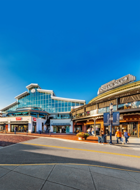  "This image shows Easton Town Center in Columbus, Ohio, designed like a charming small town, with shoppers walking along brick pathways, colorful storefronts, and seasonal decorations creating a lively retail and entertainment area."
