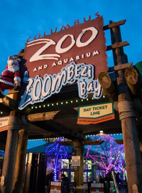 "This image shows the Columbus Zoo and Aquarium in Ohio, with families and children observing animal habitats, walking on paths lined with trees, and visiting interactive exhibits, offering an immersive wildlife experience."
