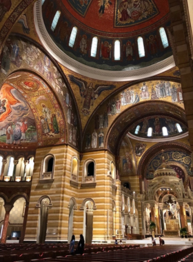 "This image shows the stunning mosaic ceiling of Cathedral Basilica, displaying intricate and colorful artwork depicting religious themes. The detailed artistry of the mosaics reflects the grandeur and beauty of this historic place of worship."