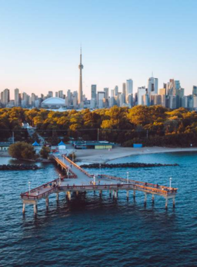 This image shows the Toronto Islands from an aerial perspective, highlighting the beautiful greenery, sandy beaches, and serene lake waters that make it a popular retreat. The islands are accessible by ferry and offer visitors an escape from the city bustle, with charming trails, picnic spots, and relaxing scenic views across Lake Ontario.