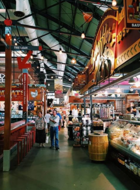 This image shows the bustling atmosphere inside St. Lawrence Market, with vibrant stalls offering fresh produce, meats, and specialty foods. The market’s rich history and variety of local and international goods make it a beloved shopping destination where food lovers can explore diverse flavors and culinary delights in Toronto.