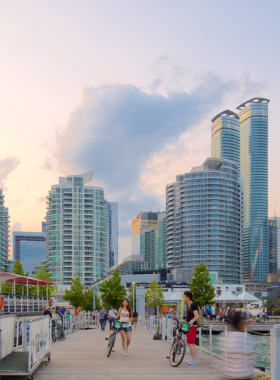  This image shows Toronto’s Harbourfront Centre with people enjoying the waterfront views of Lake Ontario. The area features open spaces, cultural venues, and scenic spots, inviting visitors to relax by the water, take boat rides, and attend festivals that celebrate Toronto’s diverse arts and culture.