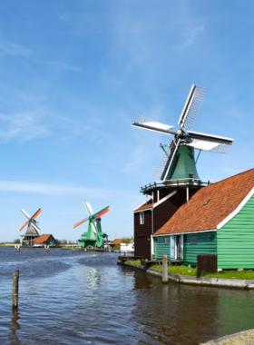  This image shows traditional Dutch windmills at Zaanse Schans, a popular open-air museum near Amsterdam where visitors can explore Dutch culture and history.
