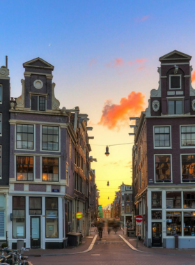  This image shows the picturesque Nine Streets district in Amsterdam, known for its boutique shops, cozy cafes, and charming canals that make it a perfect place to stroll and shop.
