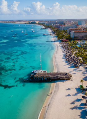  This image shows that Palm Beach in Aruba is a lively location filled with water sports, clear blue waters, and people enjoying beach activities. The vibrant atmosphere makes it a top destination for tourists.