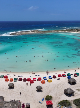 : This image shows that San Nicolas in Aruba is known for its vibrant street art, while Baby Beach offers calm, shallow waters perfect for snorkeling and relaxation, creating a unique cultural experience.