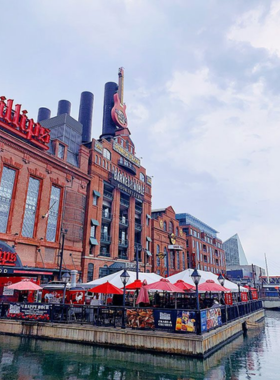 This image shows the vibrant Inner Harbor in Baltimore, featuring a scenic waterfront, docked boats, and nearby attractions like the National Aquarium, reflecting the lively and historic heart of the city.
