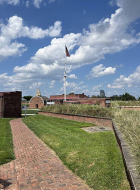  This image shows Fort McHenry’s historic site, complete with preserved structures, cannons, and an American flag flying high, symbolizing its role in the War of 1812 and its patriotic legacy.