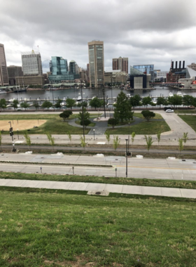  This image shows the panoramic view of Baltimore’s skyline from Federal Hill Park, with lush greenery and visitors enjoying the open space and scenic beauty.
