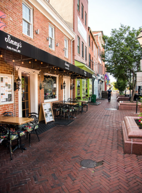 This image shows the charming cobblestone streets of Fells Point, lined with historic buildings, boutiques, and waterfront views, reflecting its maritime heritage and vibrant community.