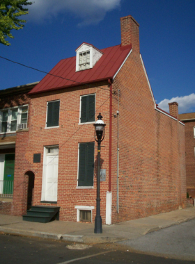  This image shows the historic brick house where Edgar Allan Poe lived, now a museum preserving his legacy with artifacts, manuscripts, and a mysterious atmosphere.
