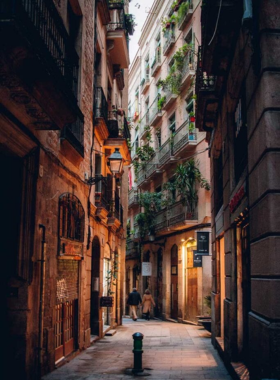 This image shows the historic Gothic Quarter of Barcelona, featuring narrow cobblestone streets, medieval buildings, and beautiful old churches, offering a glimpse into the city's rich past.

