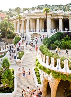 This image shows Park Güell in Barcelona, a public park designed by Antoni Gaudí, filled with vibrant mosaics, curving benches, and offering stunning views of the city.